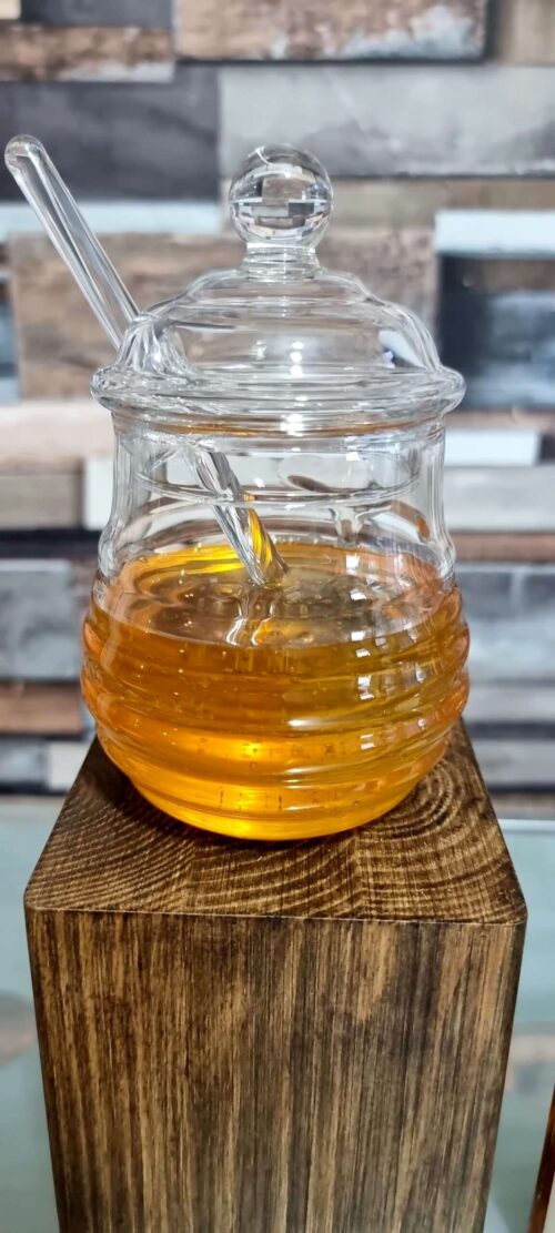 Glass honey jar with honey